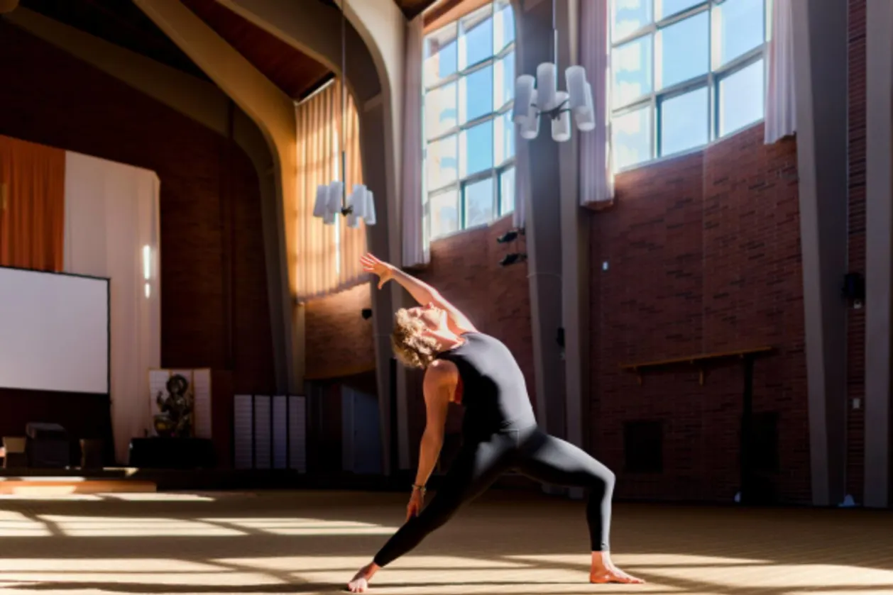 Kripalu Center sunlight shining into studio while woman is practicing yoga
